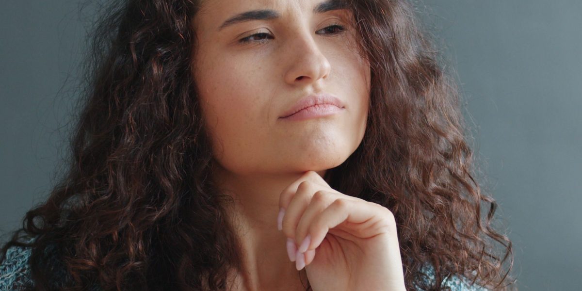 A thoughtful individual reflecting on significant life decisions and societal pressures.