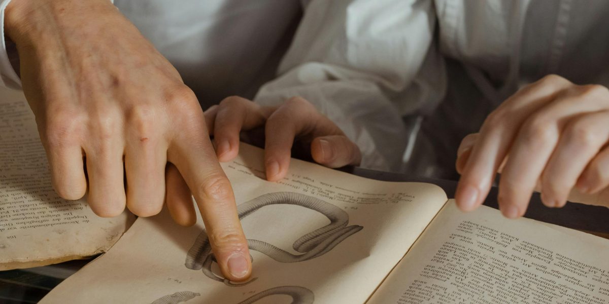 A person intently studying historical documents or old books, delving into past eras.