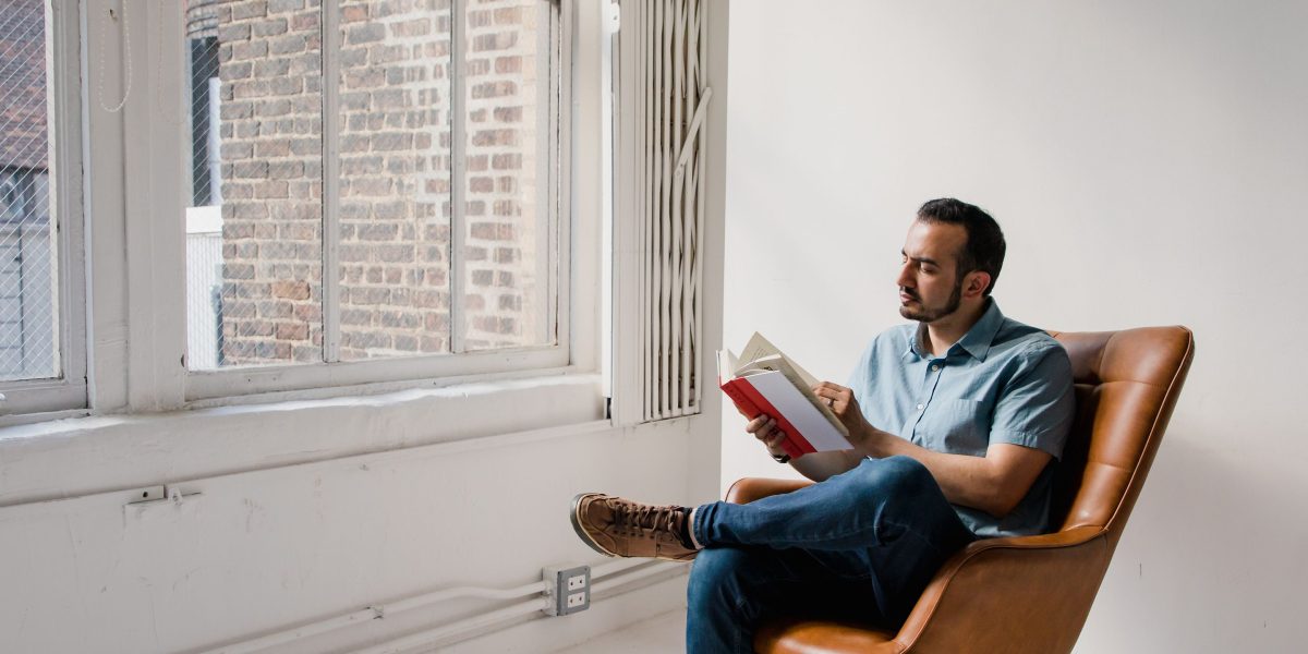 A person deeply absorbed in a book, reflecting the thoughtful and immersive nature of Murakami's novels.