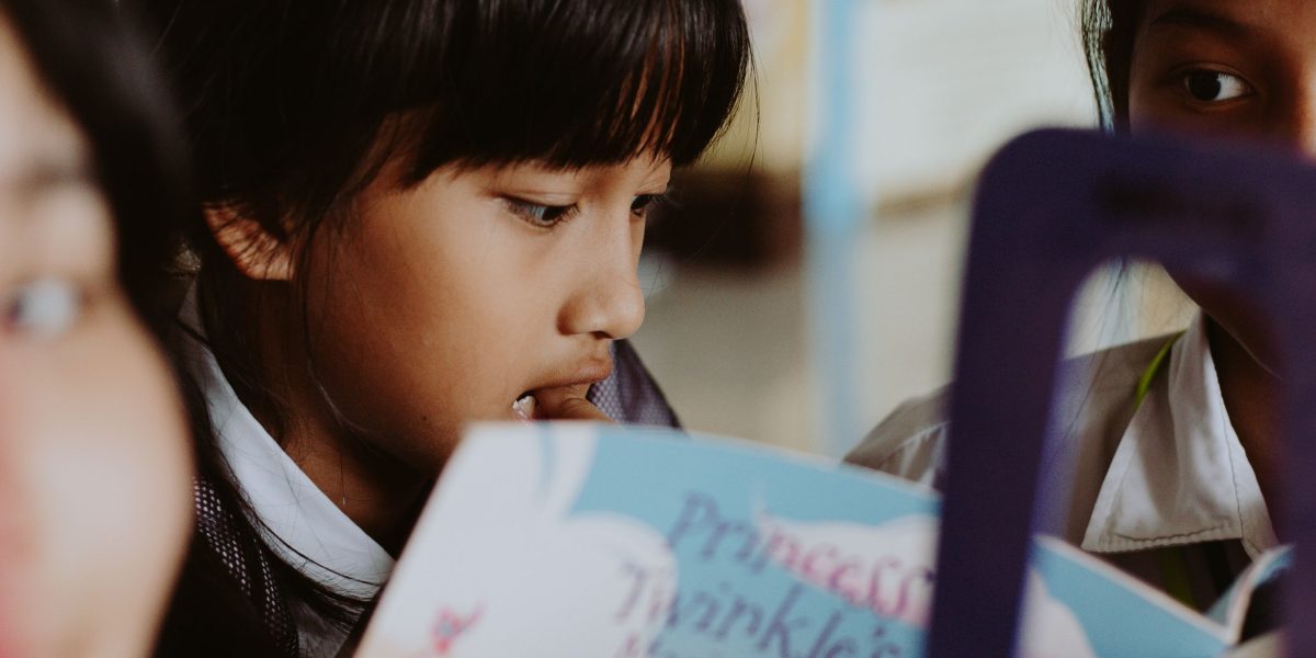 Children from varied backgrounds share stories, emphasizing the positive impact of diverse books on empathy and belonging.