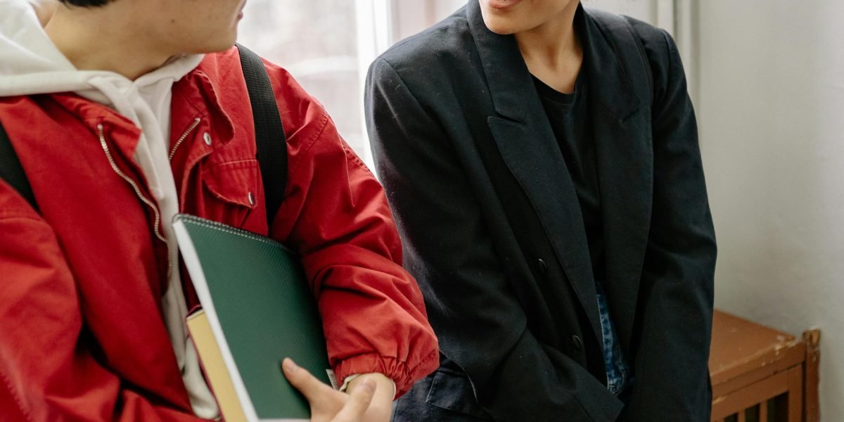 Two friends animatedly discussing a captivating book series, sharing their excitement.
