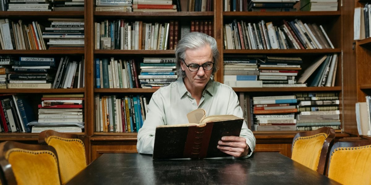 A person confidently browsing books, with a clear understanding of their reading preferences.